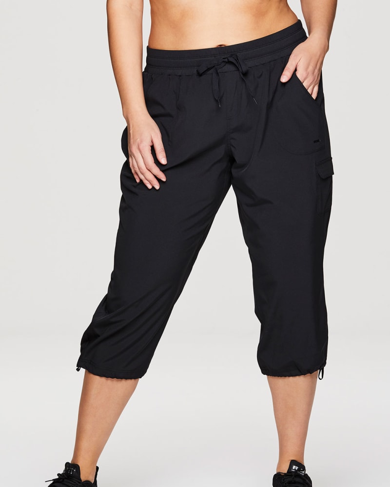 Front of a model wearing a size 2X Plus Prime Anywhere Cargo Capri in Black by RBX Active. | dia_product_style_image_id:294449